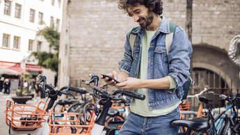 Young tourist renting an e-bike to explore Barcelona
