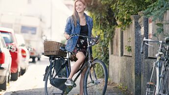 Young woan with bicycle in the city
